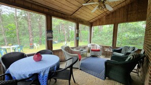 Screen porch with dining table and additional seating