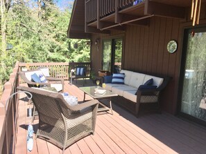 Attached deck overlooks the forest. It expands the living space greatly.