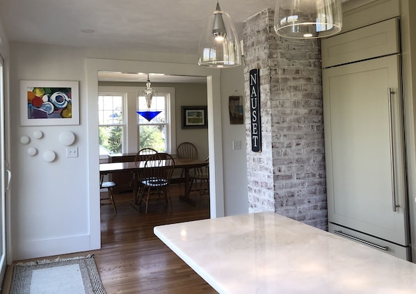 Modern Chef’s kitchen: SubZero and Thermador appliances with marble countertops.