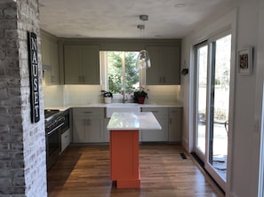 Walk from the kitchen to deck and grill from the large French doors.