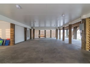 Large open space under the house designed without pilings to interrupt the space