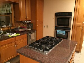 Kitchen - Six burner stovetop,  double oven & other quality appliances.