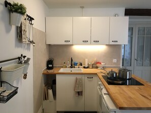 Kitchen equipped with Electric stove top oven, small fridge &Nespresso machine. 