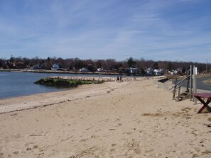 Small, sandy, association beach with fishing jetty