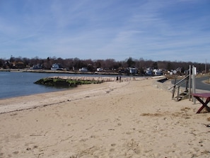 Small, sandy, association beach with fishing jetty