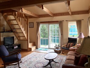 Living room leads to deck with ocean views