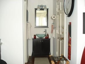 View of vanity from bedroom;  right door to balcony  and left door to bath/toile