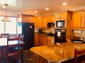 Full kitchen w/ gas range, double oven, dishwasher, full size fridge.