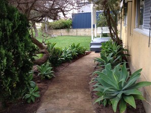 Cool Pathway leading  to front door from double secure carport. 
