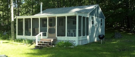 The cottage and large screen porch and Weber 22" charcoal grill