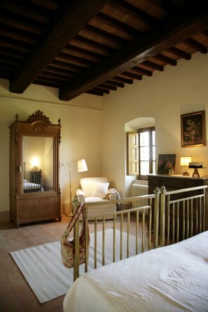 Master bedroom with view over the valley. Moraiolo, Castello di Montegiove