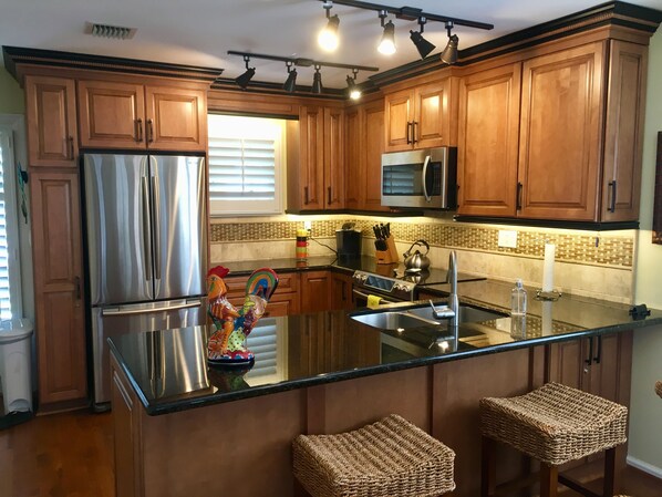 Beautiful new kitchen with granite, stainless steel and wood flooring.