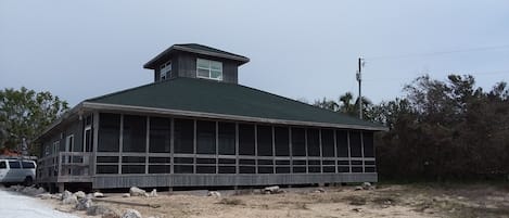 Front of house with screen porch