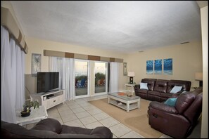 Turtle Unit - Downstairs North - Living Room with Patio Access & Oceanfront