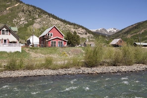 The house sits on the clear water of the Animas River.