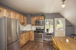 The newly remodeled kitchen with gas stove and cooktop.
