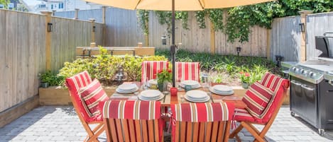 Private use patio with umbrella and cushioned seating for 6 