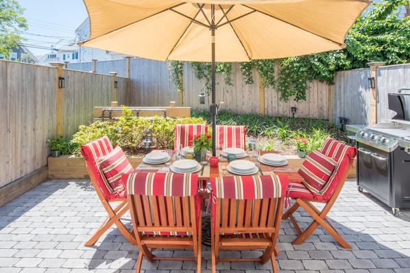 Private use patio with umbrella and cushioned seating for 6 