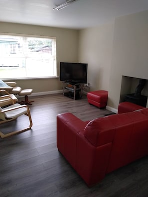 living room with cast iron stove.