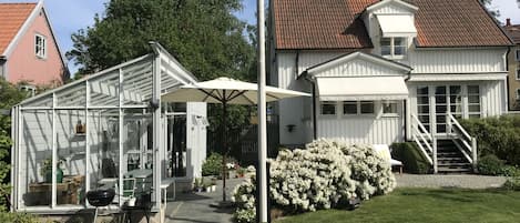 View from the garden. Main entrance and Greenhouse