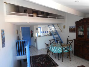 Dining area, with mezzanine above the open-plan kitchen