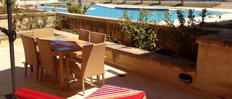 Outdoor furniture in private terrace on pool