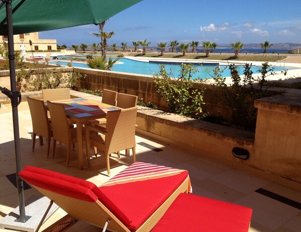 Outdoor furniture in private terrace on pool