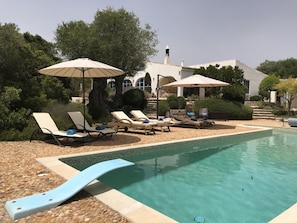 Sun loungers by the pool with diving board