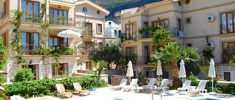 Communal pool in front of Zakkum Apartment, (on first floor with sun parasol)