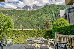 Large terrace with dining furniture and outdoor armchairs