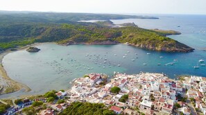 The beautiful bay and village of Es Grau as seen from the air.