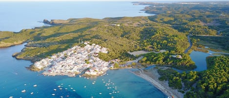 The beautiful bay and village of Es Grau as seen from the air.