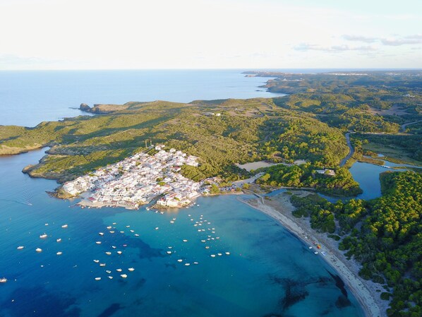 The beautiful bay and village of Es Grau as seen from the air.