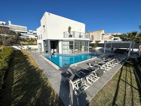 Pool area and from of house