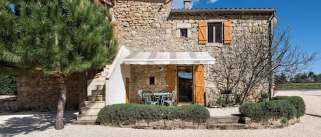 Gites Marston: La Petite Grange - The building and terrace with canopy and BBQ