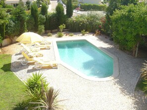 view of pool and garden from villa balcony