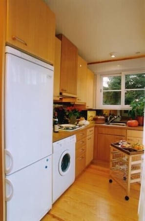 Galley kitchen leading to outdoor terrace