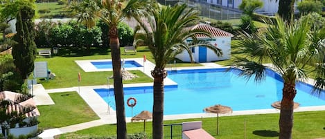 Communal pool viewed from the apartment terrace. All windows have amazing views