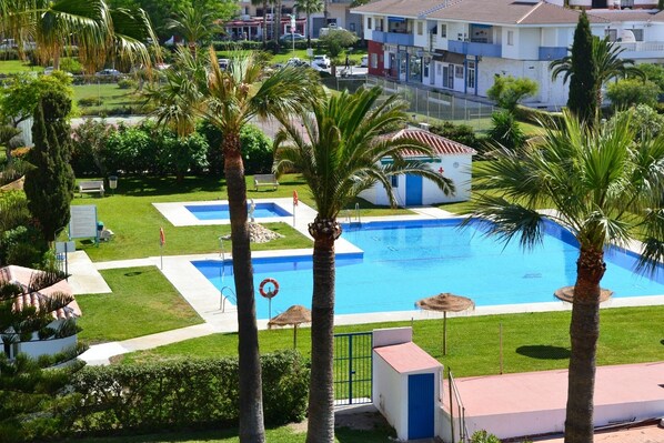 Communal pool viewed from the apartment terrace. All windows have amazing views