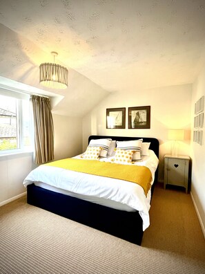 A Super King bed with two separate mattresses, one firm, one medium.