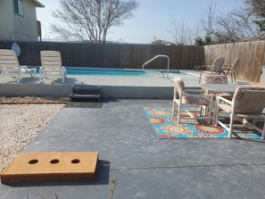 Seating & washer boards are next to the pool