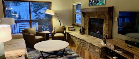 A warm and inviting living room with spacious vaulted ceiling.