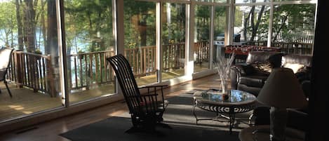 View from the atrium into the living room and out onto the deck and waterfront