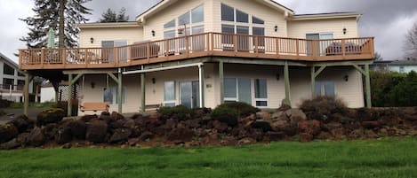 View of house with wrap-around deck