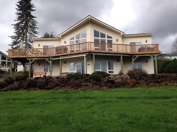 View of house with wrap-around deck