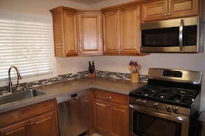 Kitchen is fully equipped and ready to prepare and serve a gourmet meal.