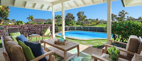 Covered lanai with pool and views of the Kiahuna golf course