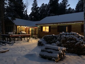 The cabin looks magical with a little snow at twilight!
