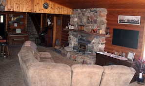Living room from the entrance on the deck. Satellite TV, DVD/VHS, and fireplace.