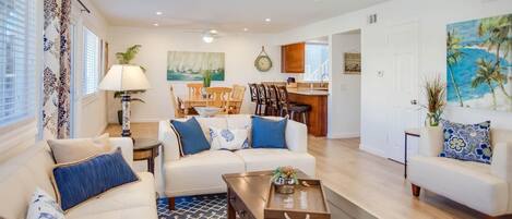 Main living spaces looking from front entry area. Open floor plan between living, kitchen and dining areas.